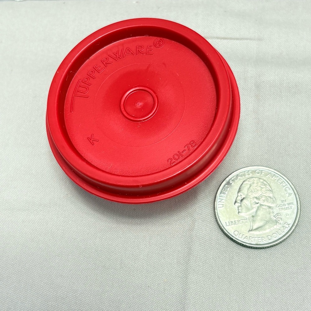 Tupperware Red lid clear bottom. Midget. Very useful for all types of storage.